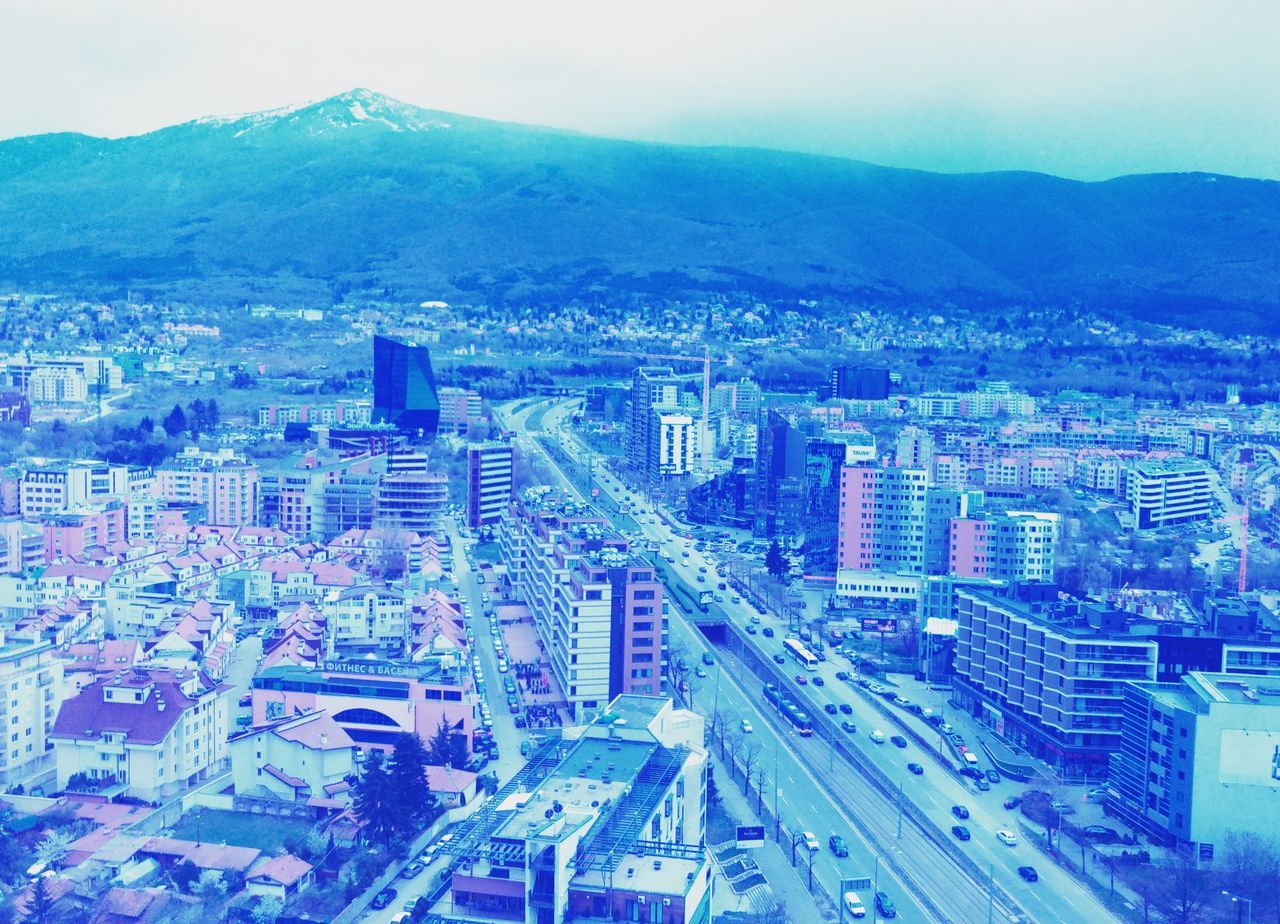 architecture, city, cityscape, sky, built structure, building exterior, blue, high angle view, transportation, modern, no people, aerial view, outdoors, growth, skyscraper, day