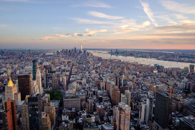 High angle view of modern buildings against sky during sunset