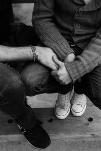 Low section of man and woman sitting on steps