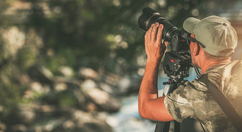 Photographer taking picture through camera