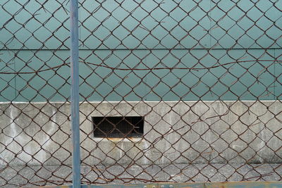 Full frame shot of chainlink fence against building