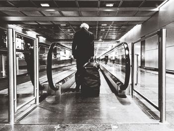 Rear view of man standing in bus