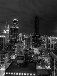 Illuminated cityscape against sky at night