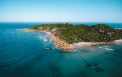 Scenic view of bay against clear blue sky