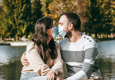 Young couple sitting on water