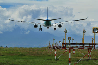 Low angle view of airplane flying against sky