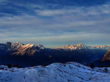 Scenic view of snow covered mountains against sky