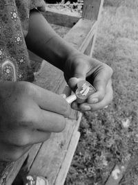 High angle view of baby hand holding wood