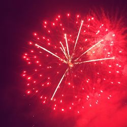 Low angle view of firework display at night