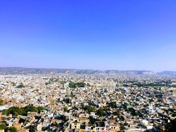 High angle view of townscape against clear blue sky