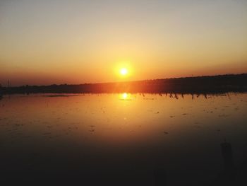 Scenic view of lake against sky during sunset