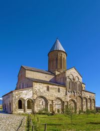 Low angle view of building against clear blue sky