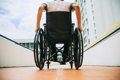 Rear view of man on wheelchair