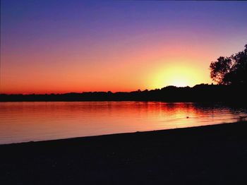 Scenic view of lake at sunset