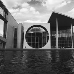 Lake against modern building in city