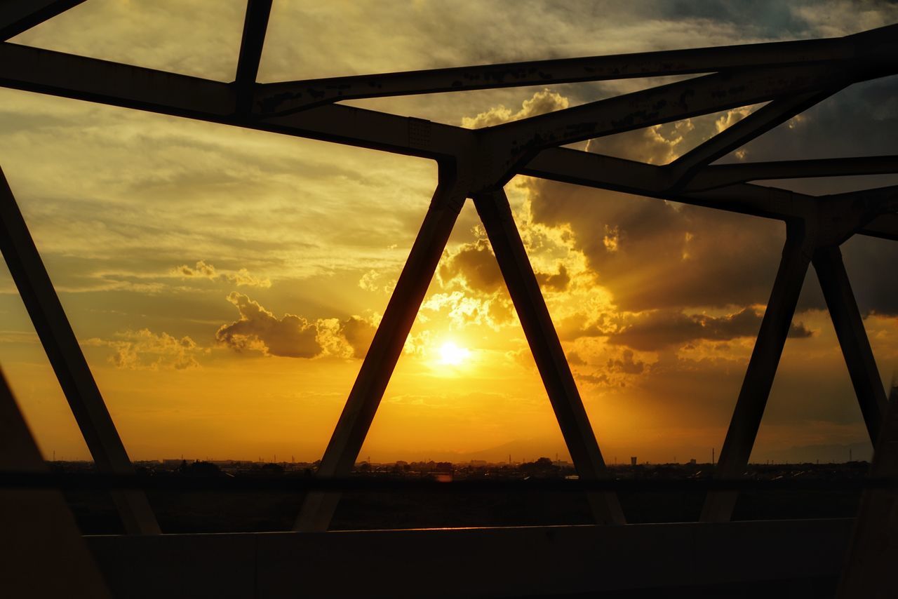 SILHOUETTE BUILT STRUCTURE AGAINST ORANGE SKY