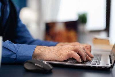 Midsection of man using laptop