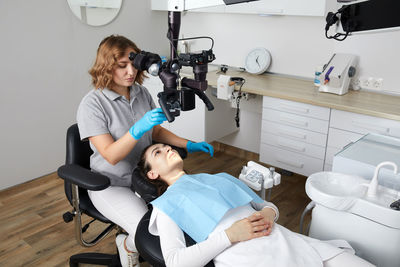 Side view of doctor examining patient at clinic