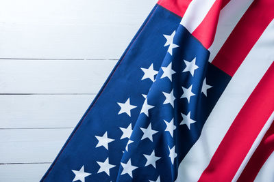 Close-up of american flag against white wall