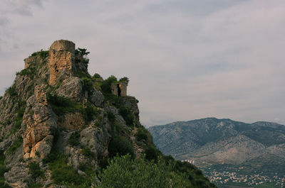 Castle on mountain against sky