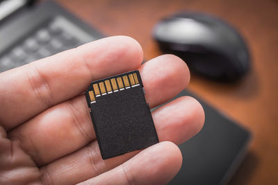 Close-up of hand holding memory card