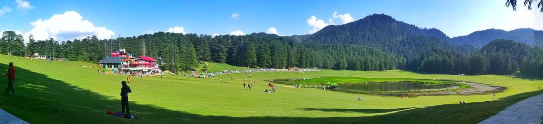 Panoramic view of green landscape against sky