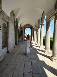 Woman standing in corridor of building