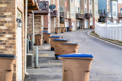 Empty seats on street by buildings in city