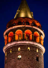 Low angle view of illuminated building against sky at night