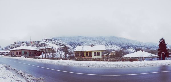 Houses against sky during winter