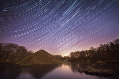 View of lake against sky at night