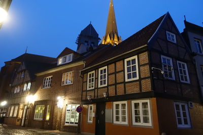 Low angle view of illuminated building against sky at night