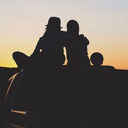 Silhouette of woman at sunset