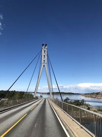 View of suspension bridge against blue sky