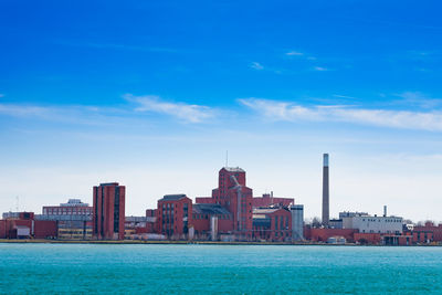 Sea against buildings in city