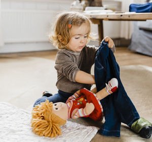 Cute girl playing with toys at home