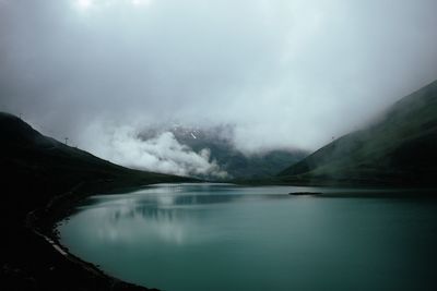 Scenic view of lake and mountains against sky