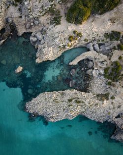 High angle view of rock formations in sea
