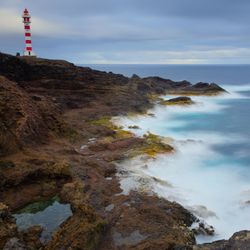Scenic view of sea and mountains against sky