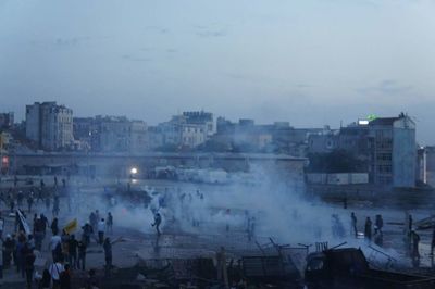 Crowd in city against sky