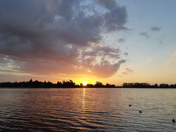 Scenic view of lake against sky during sunset