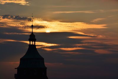 Silhouette built structure against sky during sunset