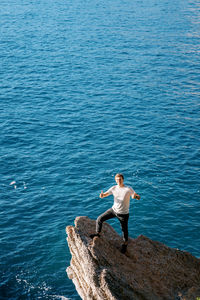 Rear view of man jumping in sea