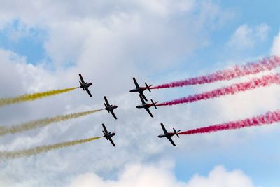 Low angle view of airshow against sky