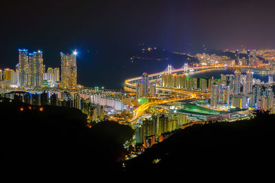 Illuminated buildings against sky at night