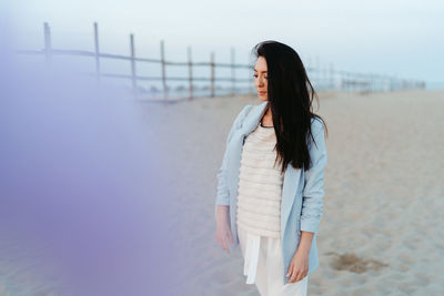 Beautiful girl walking on the beach at sunset