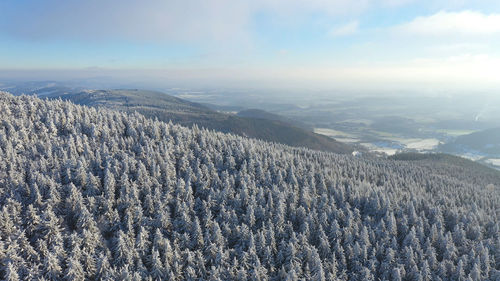 Scenic view of landscape against sky during winter