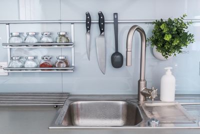 Various jars by sink in kitchen at home