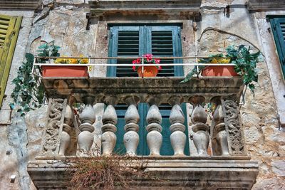 Low angle view of statues against old building