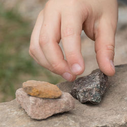 Close-up of baby hand holding rock